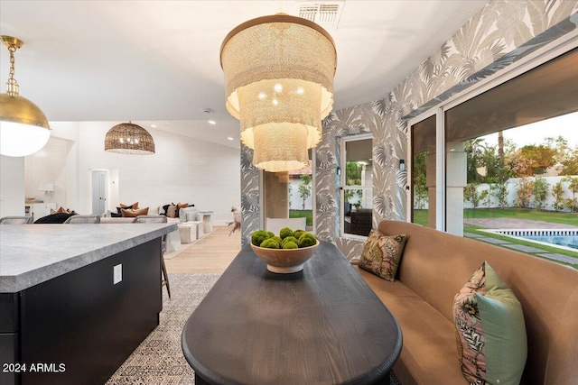 dining space with lofted ceiling and light wood-type flooring