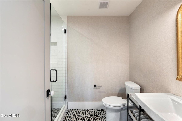 bathroom featuring toilet, walk in shower, and tile patterned flooring