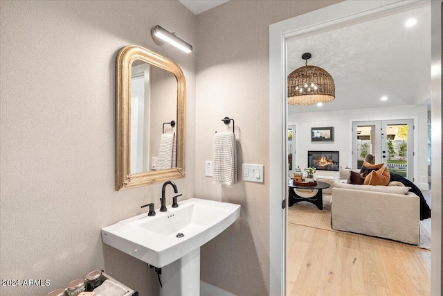 bathroom with french doors and wood-type flooring