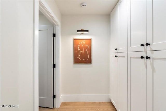 hallway with light hardwood / wood-style flooring