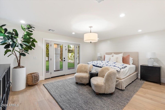 bedroom with french doors, hardwood / wood-style floors, and access to exterior