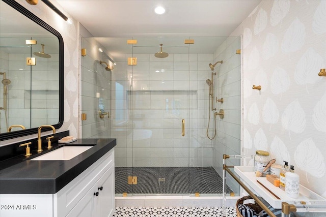 bathroom featuring vanity and a shower with door