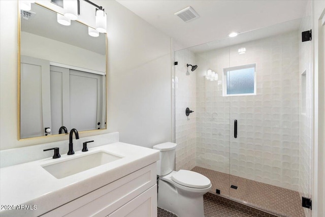 bathroom with vanity, toilet, walk in shower, and tile patterned flooring