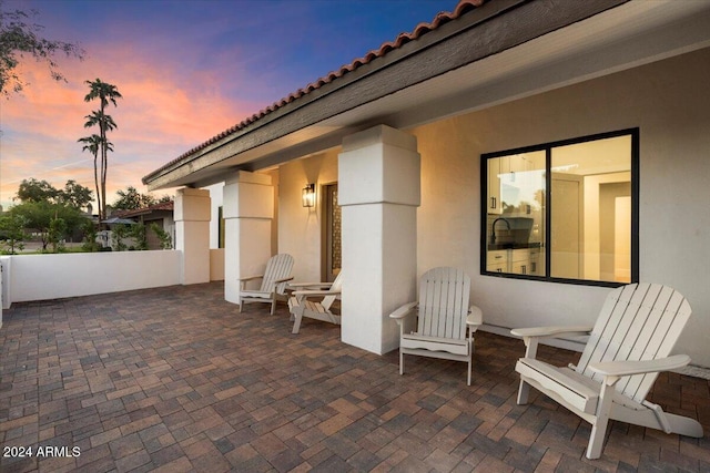 view of patio terrace at dusk