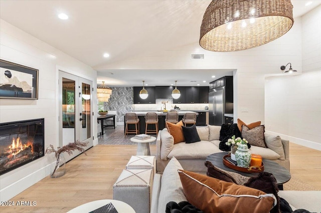 living room with light hardwood / wood-style flooring and a fireplace