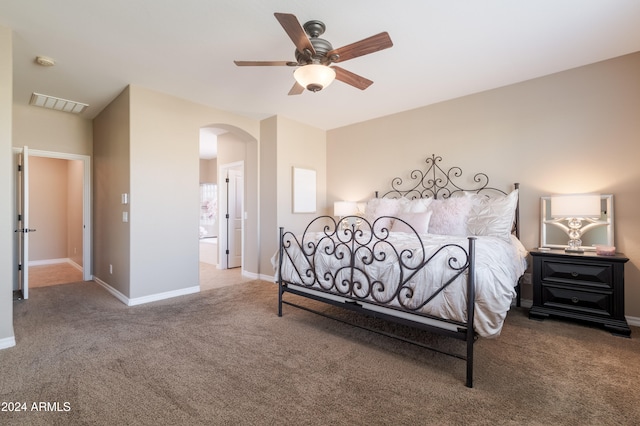 carpeted bedroom featuring ensuite bath and ceiling fan