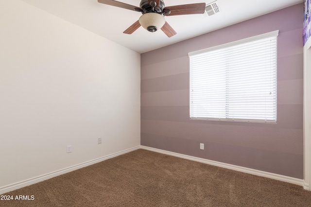 carpeted empty room featuring ceiling fan