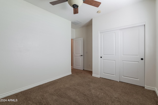 unfurnished bedroom with a closet, carpet floors, and ceiling fan