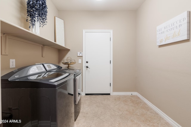 laundry room with independent washer and dryer and light tile patterned floors