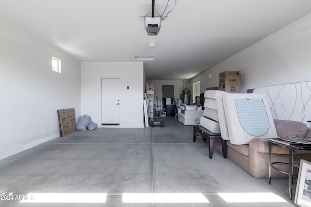 garage featuring a garage door opener and water heater