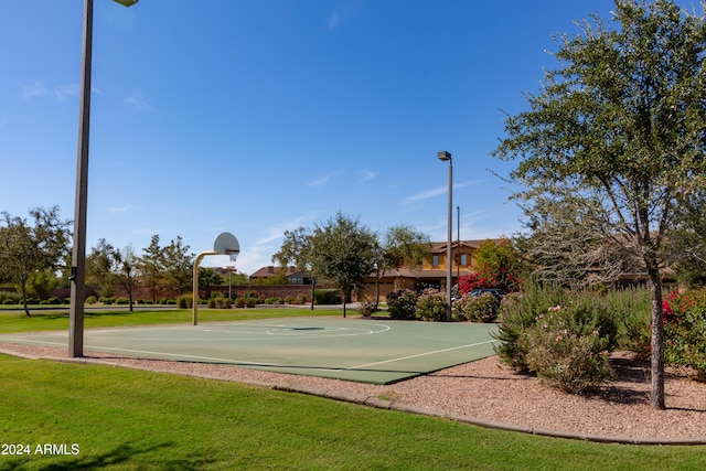 view of sport court with a yard