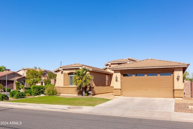 view of front of house featuring a front yard and a garage