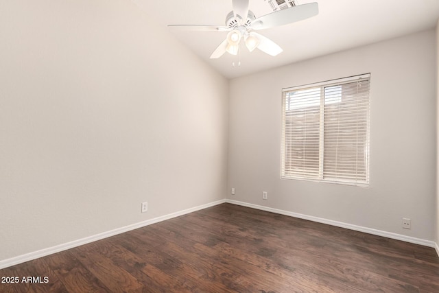 empty room featuring a ceiling fan, baseboards, lofted ceiling, dark wood-type flooring, and visible vents