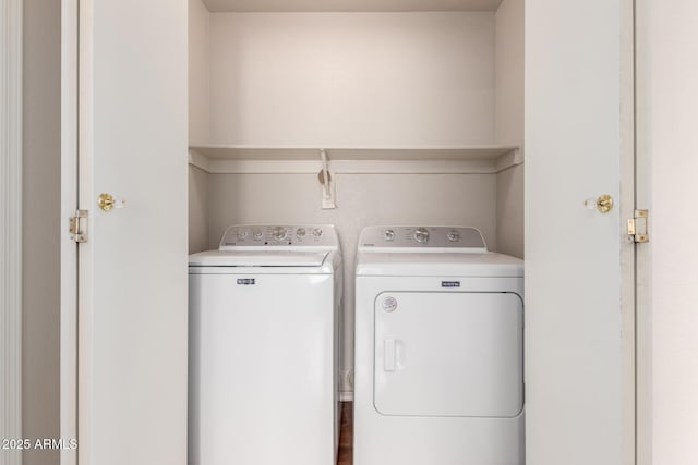 clothes washing area featuring laundry area and washing machine and clothes dryer