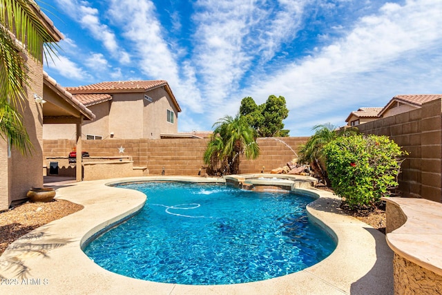 view of swimming pool featuring a fenced backyard and a pool with connected hot tub