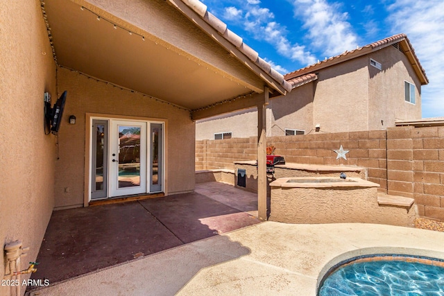 view of patio / terrace with fence and a jacuzzi