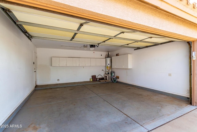 garage featuring baseboards, a garage door opener, and water heater