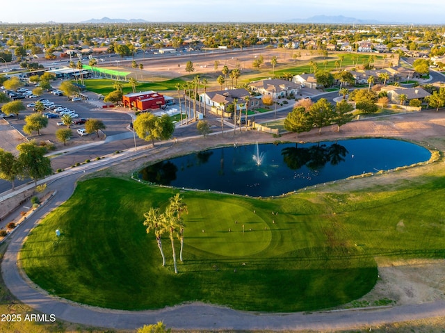 drone / aerial view featuring a residential view, a water and mountain view, and golf course view