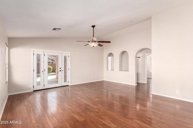 unfurnished living room featuring visible vents, wood finished floors, baseboards, ceiling fan, and vaulted ceiling