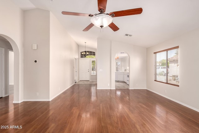 unfurnished living room featuring arched walkways, visible vents, wood finished floors, and lofted ceiling