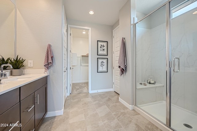 bathroom featuring vanity and a shower with shower door