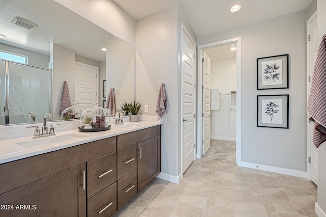 bathroom with walk in shower and vanity