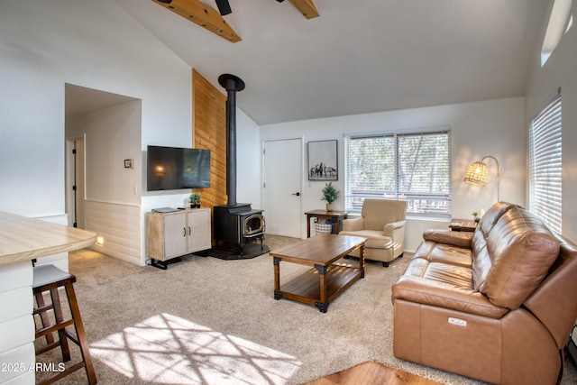 2273 Trail Cir, Overgaard, AZ 85933 - living area featuring a wood stove, high vaulted ceiling, carpet flooring, healthy amount of natural light, and ceiling fan