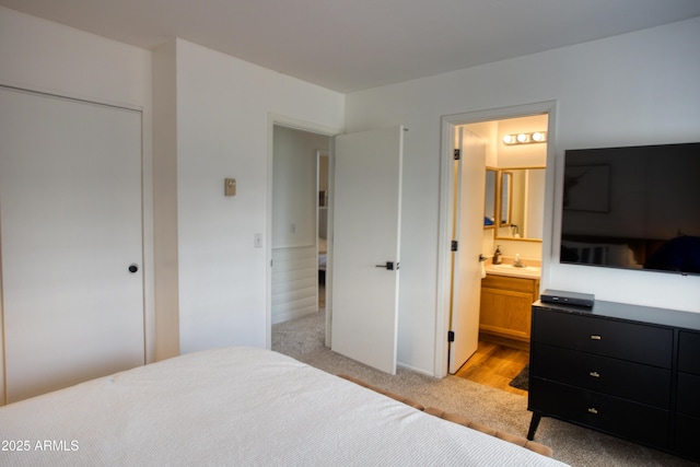 2273 Trail Cir, Overgaard, AZ 85933 - bedroom with light carpet, ensuite bath, and a sink