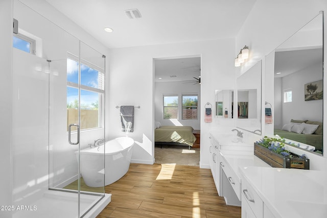 8140 E June St, Mesa, AZ 85207 - bathroom with a shower stall, wood finished floors, double vanity, a ceiling fan, and ensuite bathroom