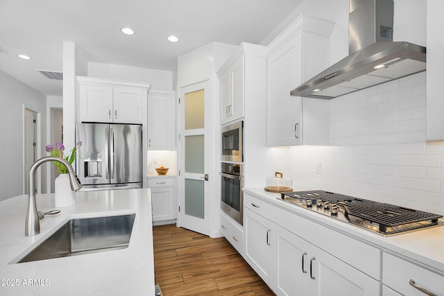 8140 E June St, Mesa, AZ 85207 - kitchen featuring stainless steel appliances, visible vents, a sink, wall chimney exhaust hood, and white cabinetry