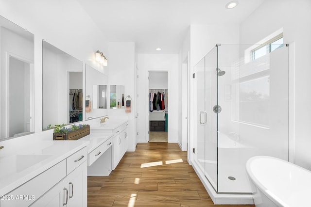 8140 E June St, Mesa, AZ 85207 - bathroom featuring a shower stall, wood finished floors, a freestanding tub, vanity, and recessed lighting