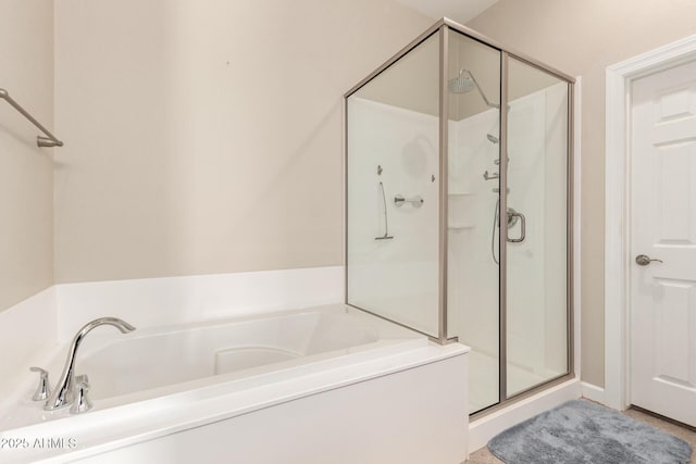 bathroom featuring shower with separate bathtub