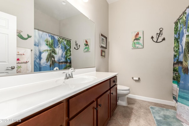 bathroom featuring vanity, tile patterned floors, and toilet