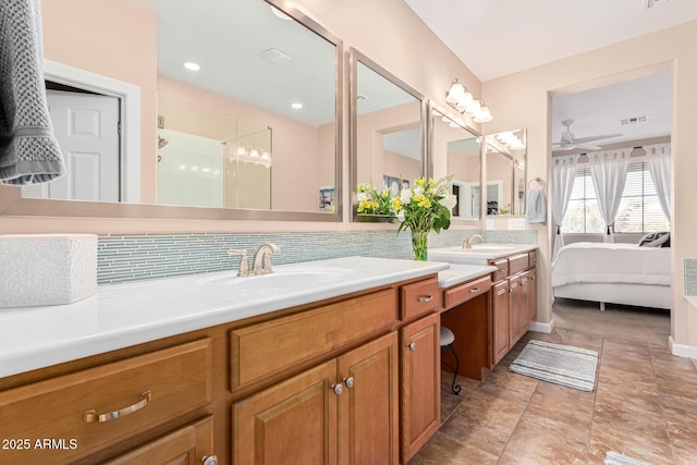 bathroom featuring ceiling fan, vanity, and backsplash