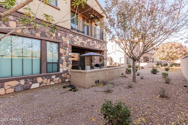 back of property featuring a balcony