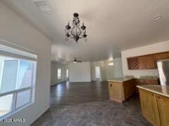 500 S Santa Fe Trl, Cornville, AZ 86325 - kitchen featuring a chandelier, brown cabinetry, decorative light fixtures, and open floor plan