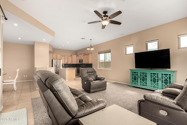 living room with light tile patterned floors, recessed lighting, baseboards, and ceiling fan