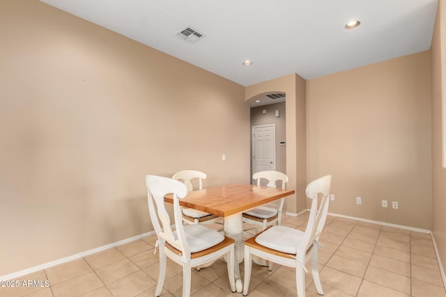 dining room with light tile patterned floors, baseboards, and visible vents