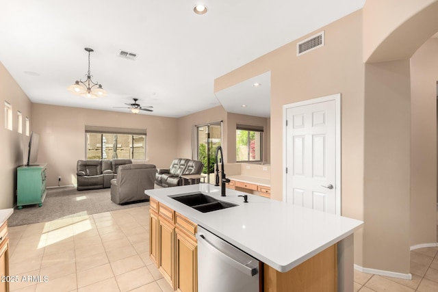 kitchen featuring dishwasher, light countertops, visible vents, and a sink