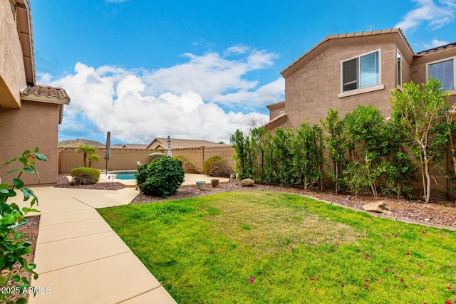 view of yard with a patio area, a fenced in pool, and a fenced backyard