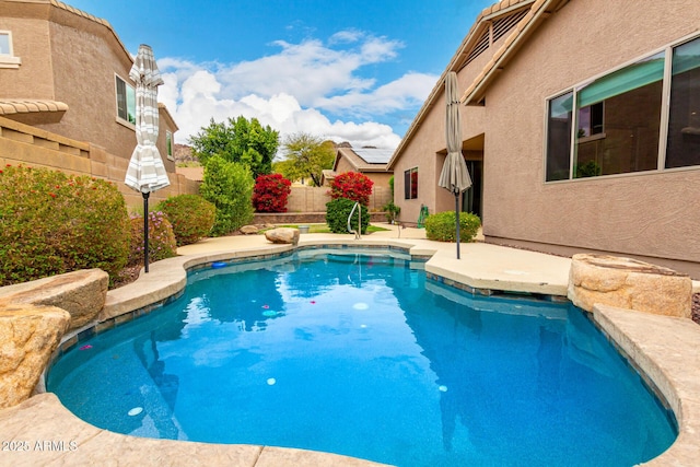 view of swimming pool featuring a patio area, fence, and a fenced in pool