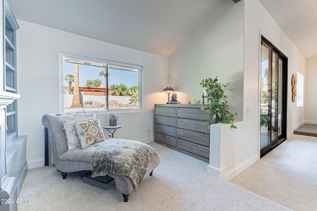 sitting room with vaulted ceiling, carpet flooring, and baseboards