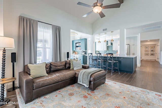 living room with high vaulted ceiling, ceiling fan, visible vents, and dark wood-style flooring