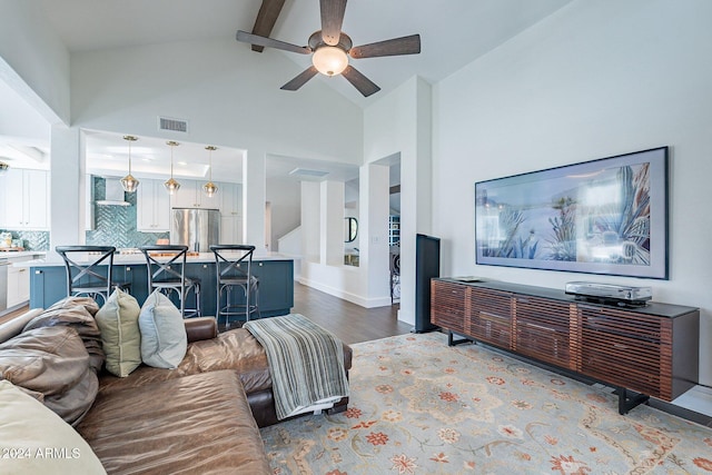 living room with beam ceiling, visible vents, ceiling fan, wood finished floors, and high vaulted ceiling