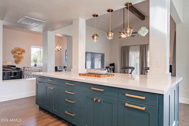 kitchen with a healthy amount of sunlight, visible vents, dark wood finished floors, and open floor plan