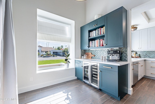 bar with baseboards, dishwasher, wine cooler, wood tiled floor, and backsplash