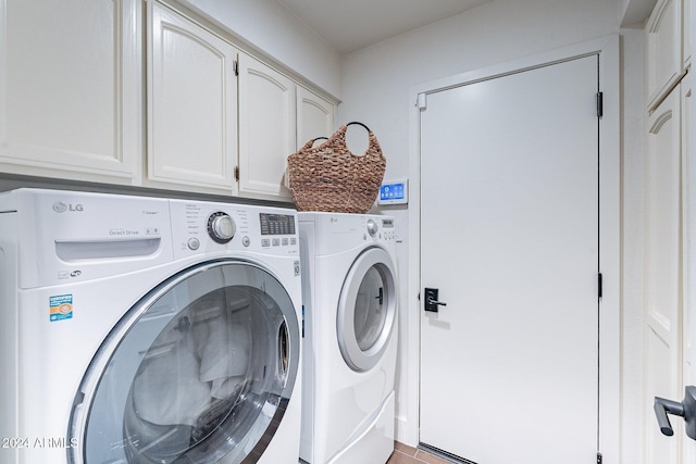 washroom with cabinet space and washer and clothes dryer