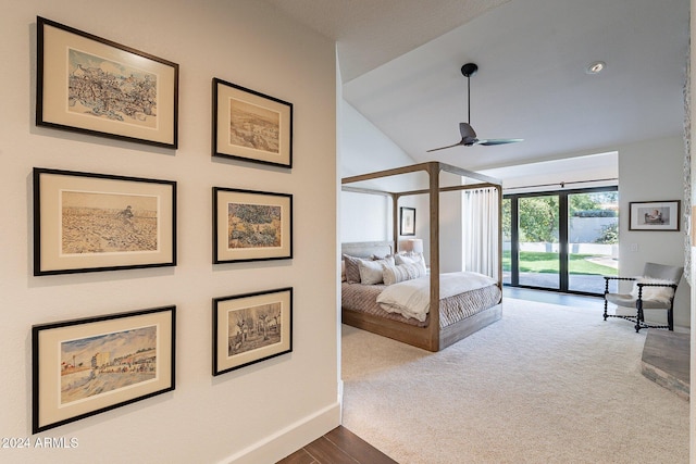 carpeted bedroom featuring access to exterior, lofted ceiling, baseboards, and a ceiling fan