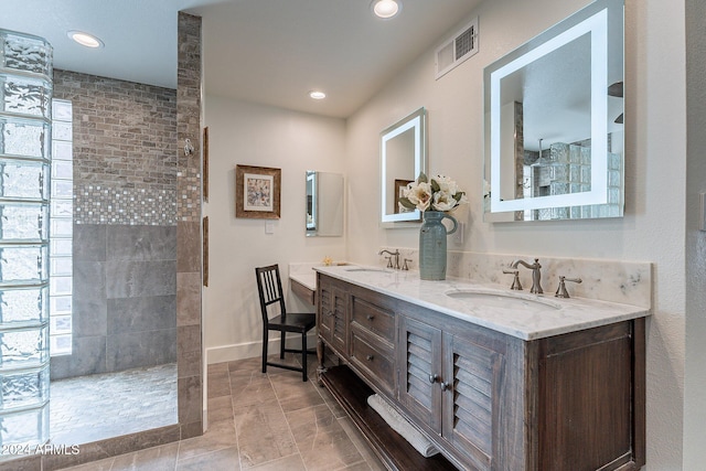 full bathroom featuring a walk in shower, a sink, and visible vents