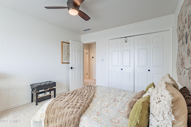 carpeted bedroom with baseboards, ceiling fan, visible vents, and a closet